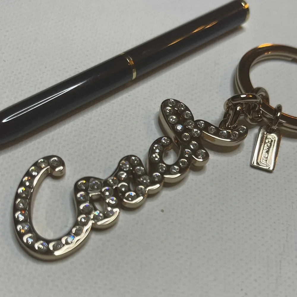 Coach Gold Rhinestone Keychain with a Black Coach Pen